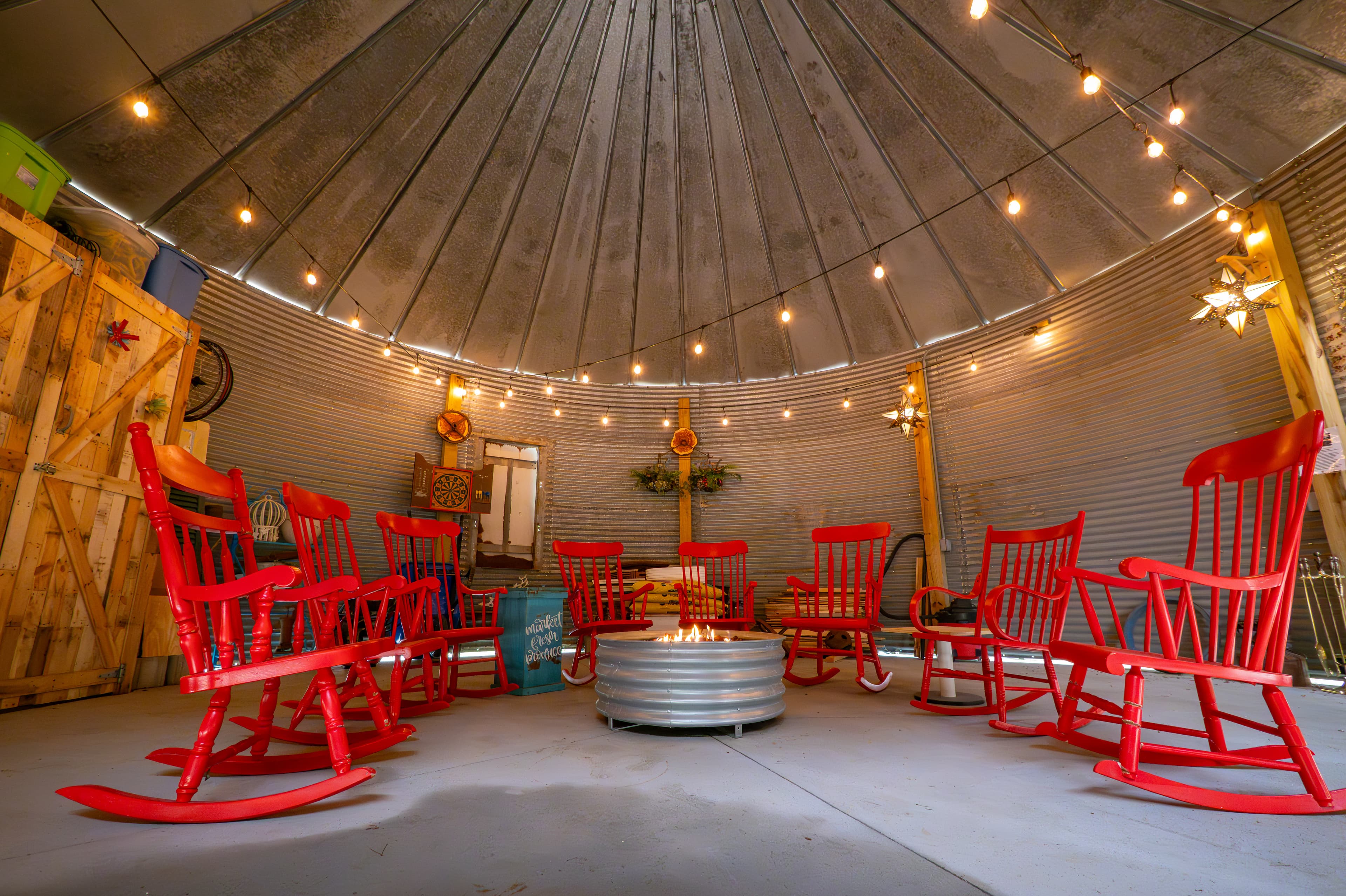 Covered gas fire pit complete with red rockers to tell your stories and build memories