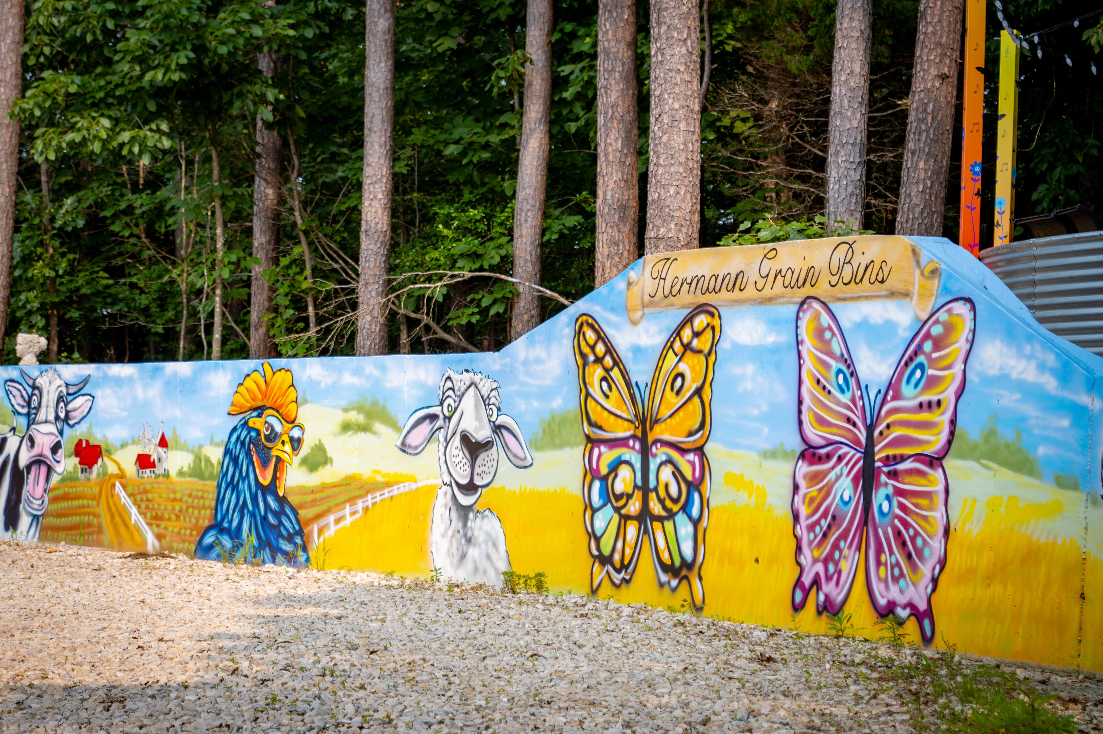 Artist painted memorial wall for your photo ops in front of butterfly angels