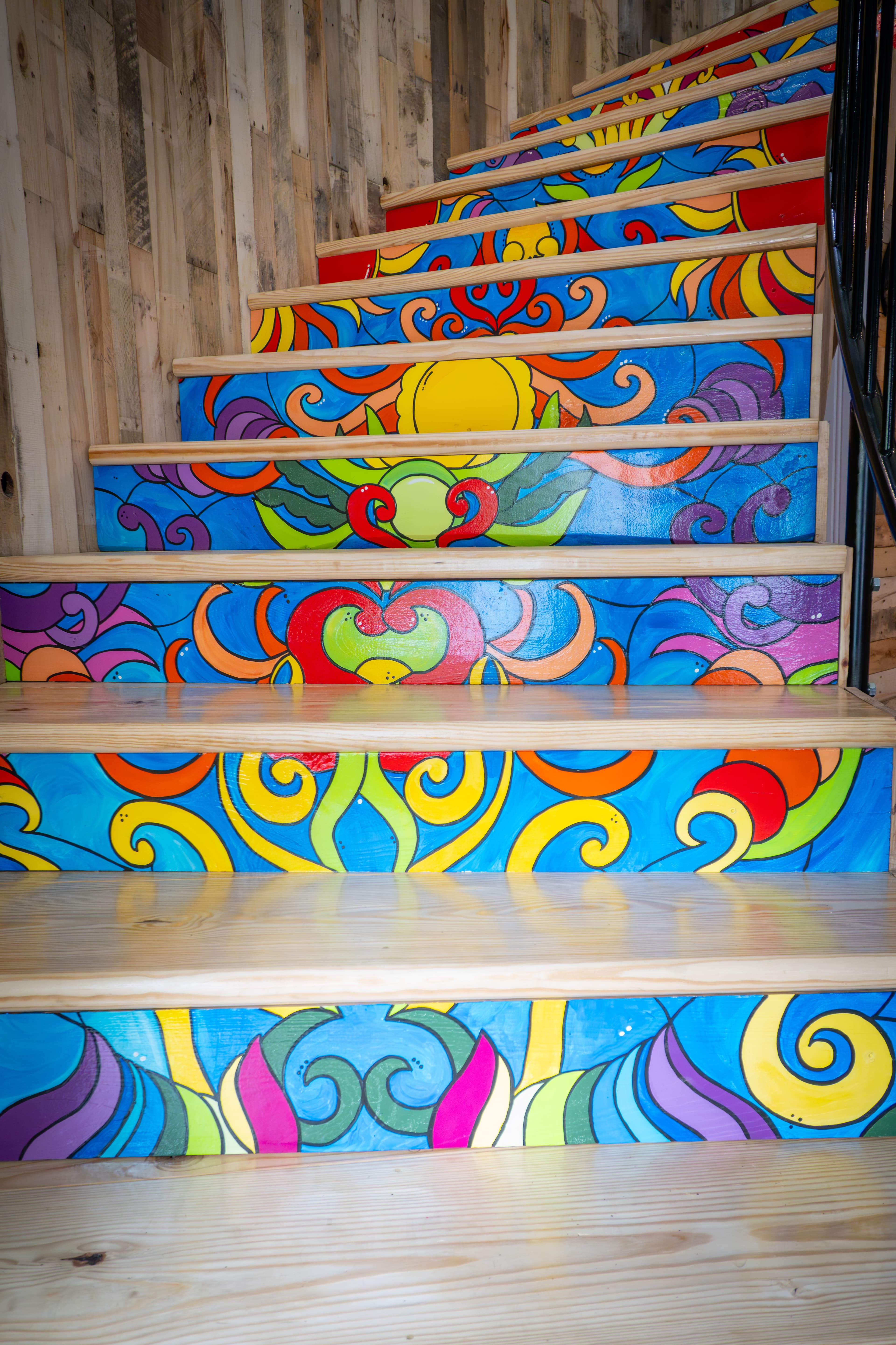 Artist hand painted radius staircase leading up to balcony level