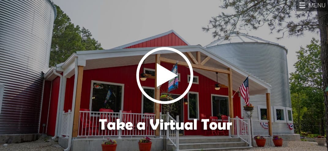 Exterior view of a red building with silos and a "Take a Virtual Tour" button.