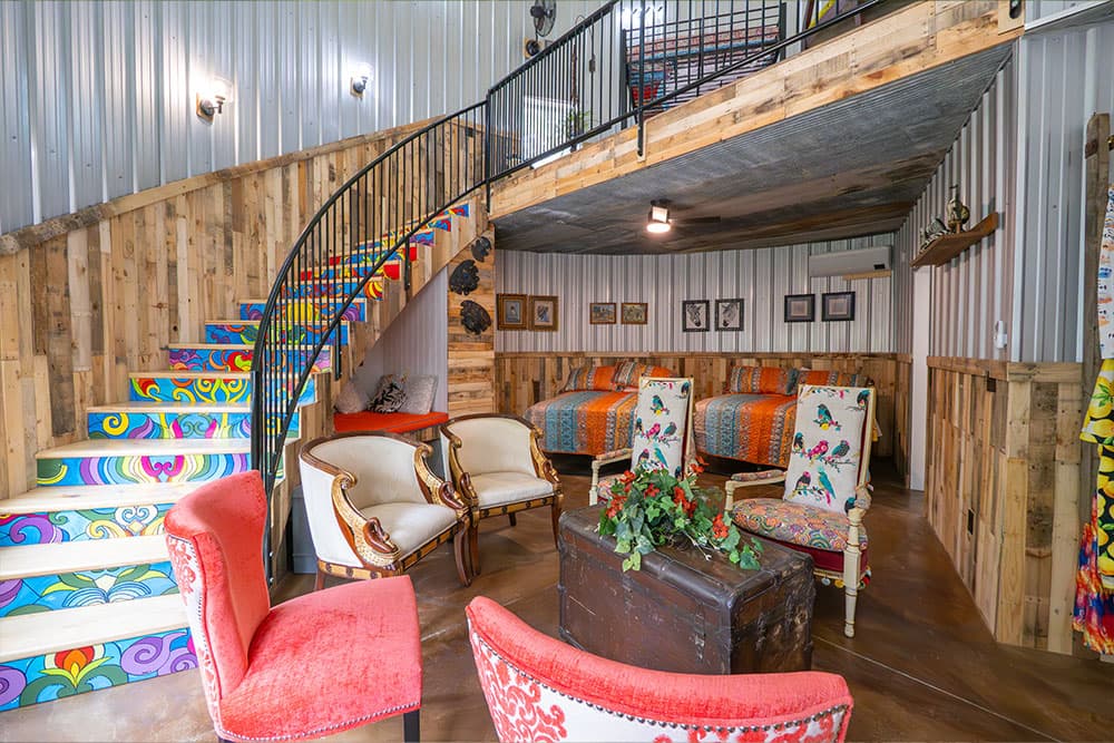 A cozy interior featuring colorful stairs, vintage furniture, and vibrant decor.